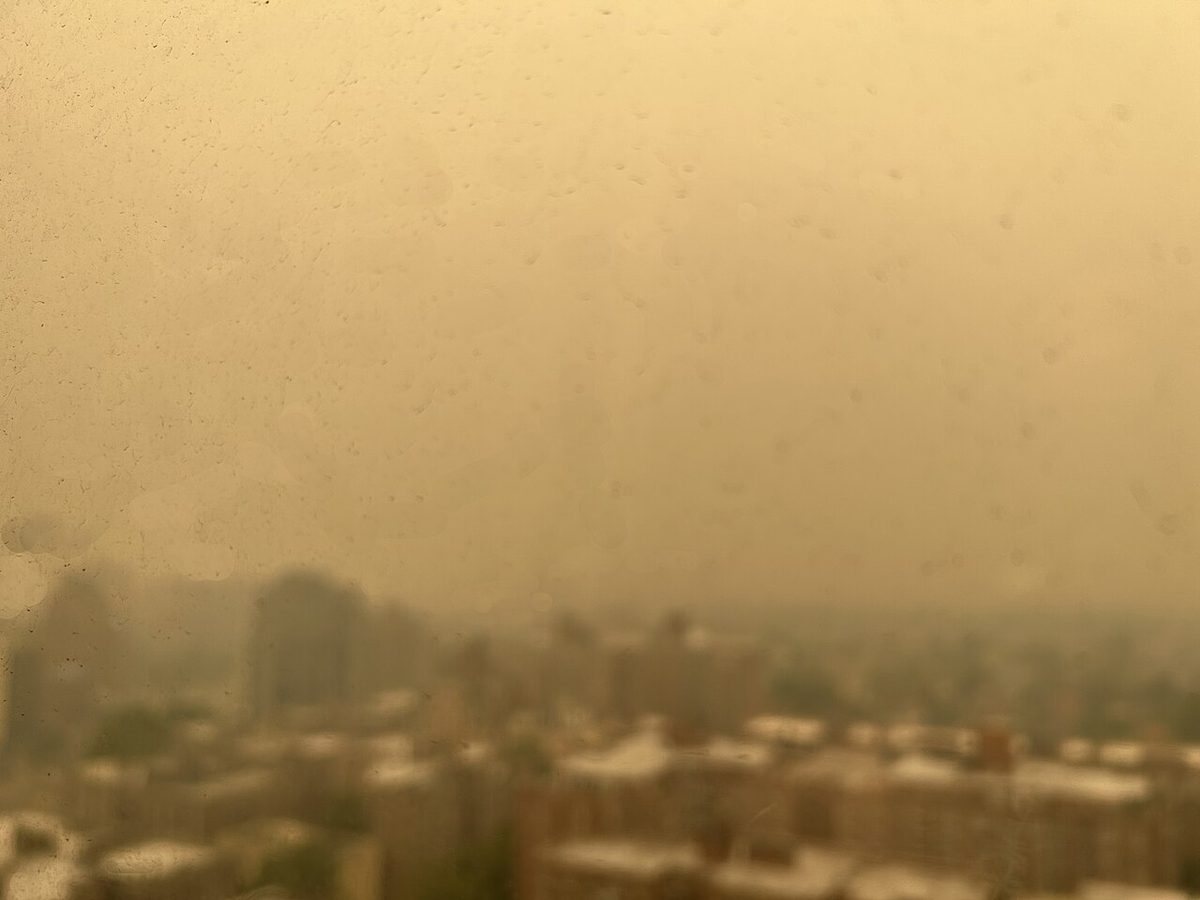 The Manhattan skyline disappearing into orange wildfire haze